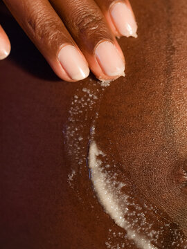 Applying moisturizer on belly 
