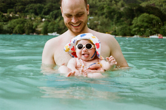 Father and child enjoy water play at the beach