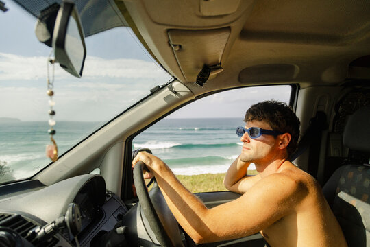 Man driving campervan along east Australia surf coast