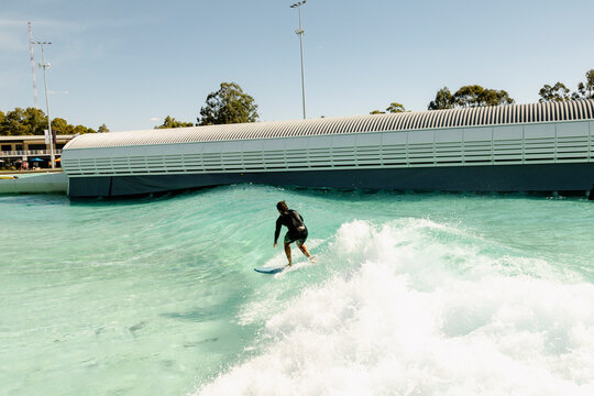 UGC surfer riding wave in outdoor wave pool