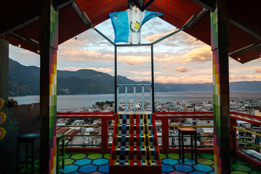 Guatemala flag on colorful rooftop viewpoint overlooking Lake Atitl&aacute;n