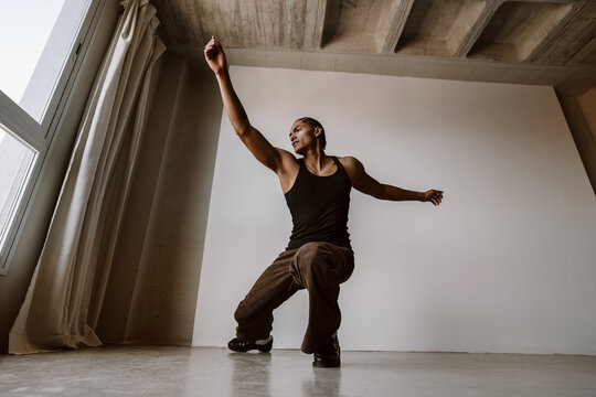 Young man dancing urban style inside studio