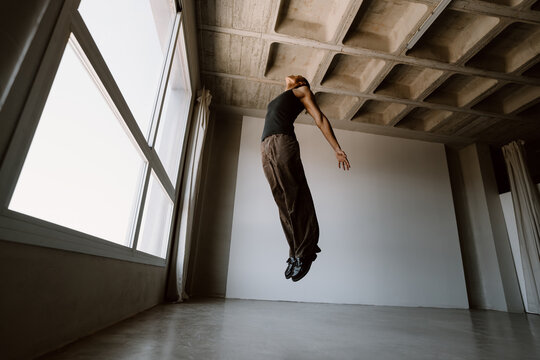 Contemporary dancer jumping in studio