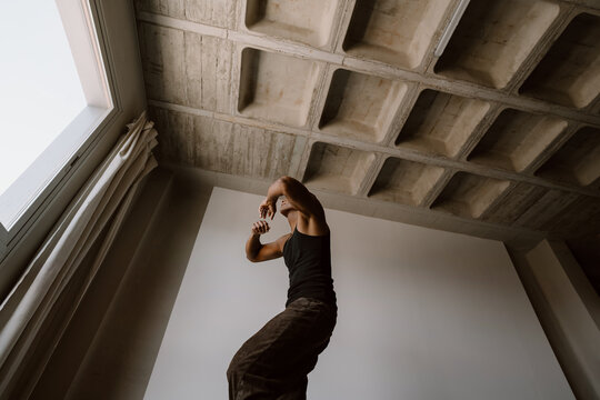 Young man dancing urban style inside studio