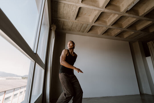 Young man dancing urban style inside studio