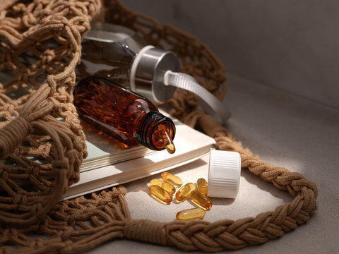 Amber bottle with omega-3 capsules and a glass water bottle