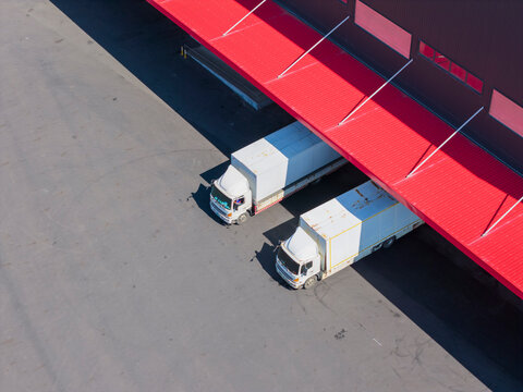 Aerial View of Trucks at Red Warehouse Loading Dock