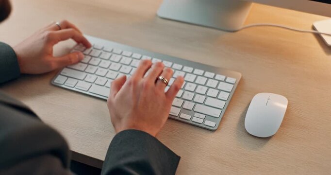 Close up of businessman hands typing on wireless keyboard in modern office