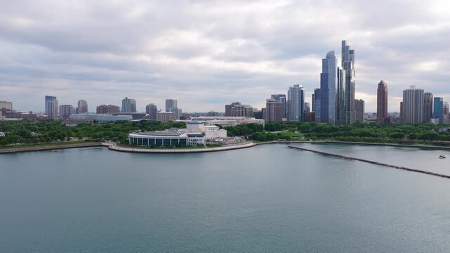 Chicago cityscape flying over Lake Michigan revealing Streeterville neighborhood with modern glass buildings and renowned Jardine Water Purification Plant