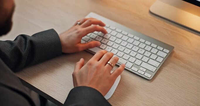 Businessman hands typing on computer wireless keyboard and using mouse at wooden office desk