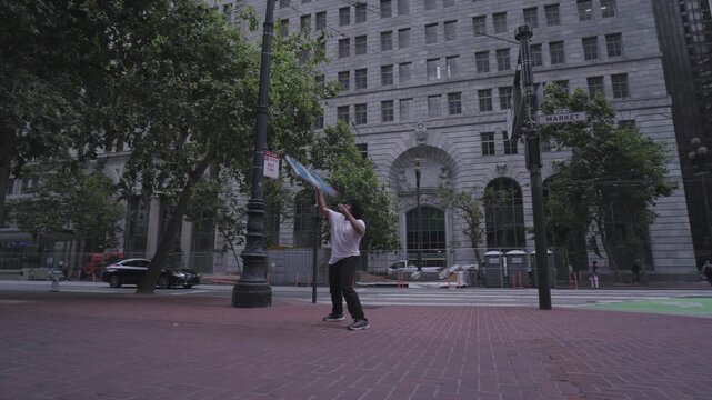 Man Spinning Large Colored Flag on Downtown Plaza Market Street