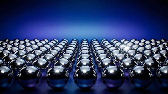 Array of shiny reflective spheres aligned in a geometric pattern against a dark blue background