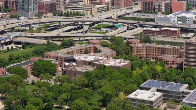 Urban landscape in Chicago showing University of Illinois Chicago East Campus with residential apartment buildings and cars driving on Jane Byrne Interchange