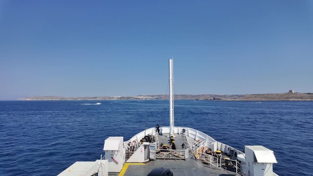 Cirkewwa, Malta - 29.06.2026 - Fast Ferry ride from Corkewwa, Malta to Mgarr harbour on Gozo. Comino island with Santa Marija tower on the right. High quality 4k footage