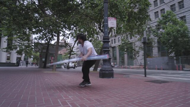 Man Doing Cool Tricks And Flips With Painted Board on Brick Plaza In San Francisco