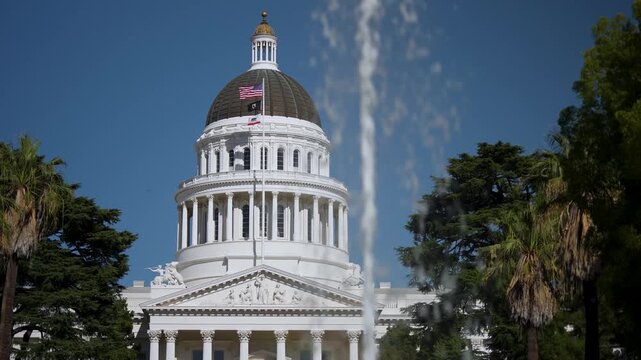 Explore the California State Capitol in Sacramento on a sunny day with the dome and trees visible in the background as people walk around