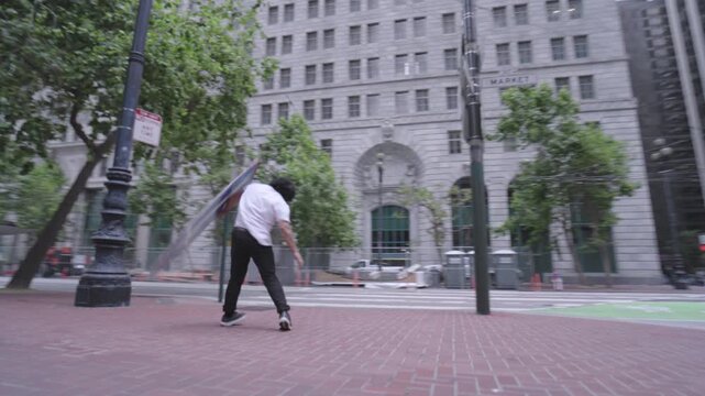 Man Swinging Painted Board at Downtown San Francisco Crosswalk - Steady Cam Wide Shot