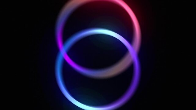 Abstract blue, purple and pink gradient glowing circles rotating. Looping animated background