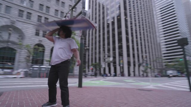 Man Throwing Painted Board Skyward In San Francisco - Low, Steady Cam Arcing Shot