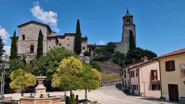 Greccio Italy 4K. Handheld focus pull from handmade knitted yarn decorations on trees to historic town square fountain. Beautiful medieval borgo lifestyle detail b roll cinematic video asset