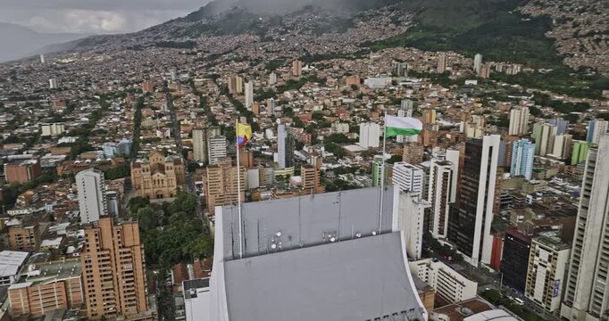 Medellin Colombia Aerial v55 fly around tallest skyscraper, Coltejer building capturing flags waving on top of the tower and La Candelaria downtown cityscape - Shot with Mavic 3 Cine - November 2022