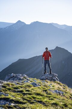 Hiker enjoying the mountain panorama in the morning, Venediger group, behind Dreiherrenkopf, Simonysitze and Gro&szlig;er Geiger, Hohen Tauern, Austria