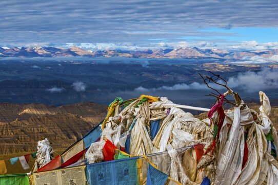 Prayer flags over the eroded mud landscape in the kingdom of Guge, Western Tibet, Asia