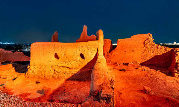 Illuminated ancient mud brick ruins of the At Turaif World Heritage Site at night in Diriyah, Saudi Arabia
