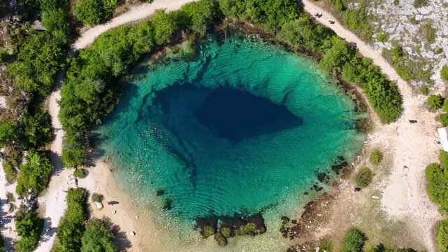 Aerial view of the Cetina River spring, known as the Eye of the Earth, a karst spring in Croatia with crystal clear turquoise water
