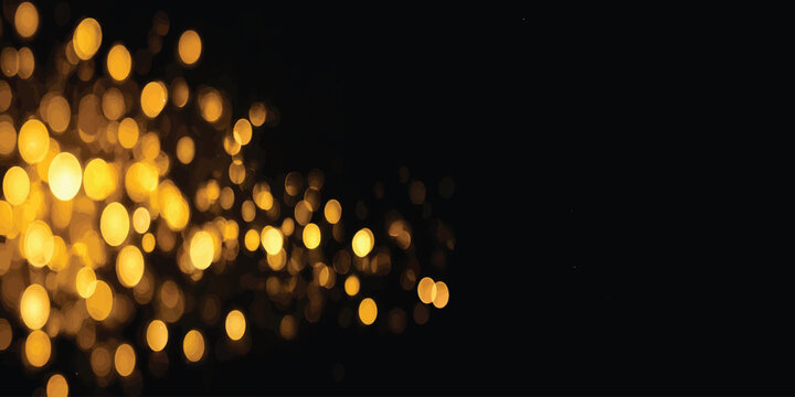 Golden bokeh light effect streaming from left side on dark black background with abstract background defocused glamorous illumination sparkling radiance artistic wallpaper spotlight
