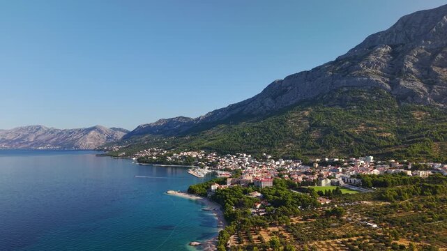 Aerial view of Brela town on the Makarska Riviera in Croatia, Adriatic Sea coastline with mountains and pine forest
