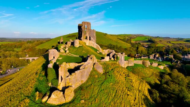 Aerial sunset view of Corfe Castle, a village and civil parish in the English county of Dorset, UK