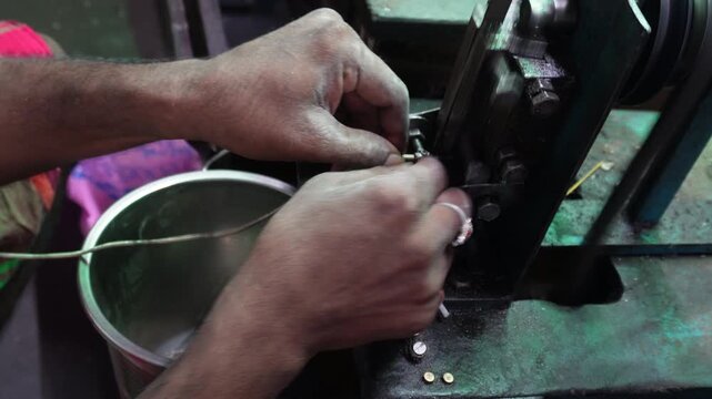 Silver jewelry cutting by skilled artisan in workshop