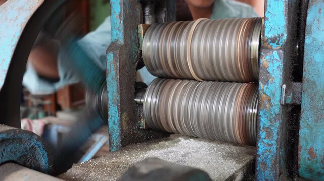 Goldsmith rolling mill shaping gold and silver