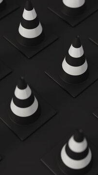 High angle grid of traffic cones in white and black on a black background for road safety and construction warning. Vertical video.