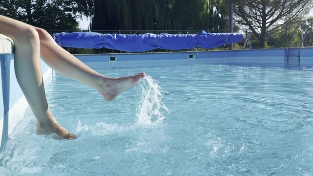 Relaxing summer day by the pool with splashing feet