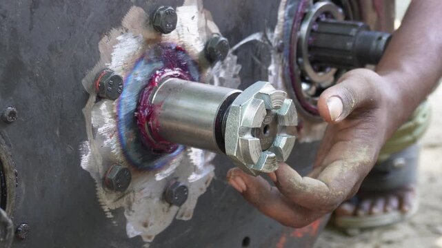 Mechanic tightening castle nut on axle hub