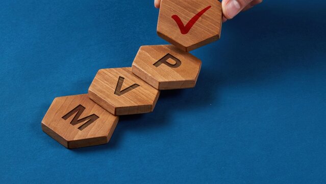 Wooden hexagonal blocks with mvp letters and a red checkmark