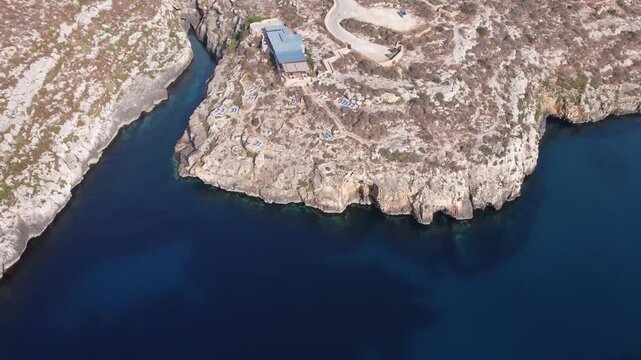 Ix-xini, Gozo, Malta - serene aerial view of rocky coastline with rugged terrain and blue water in natural landscape. High quality 4k footage
