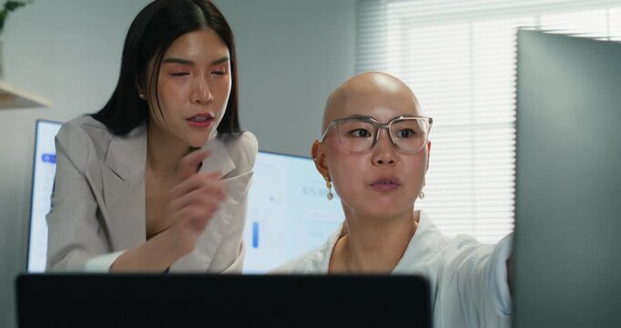 Professional Asian executives share expertise and guidance during a project briefing. Focused on corporate partnership, management strategy, and togetherness in a modern office.