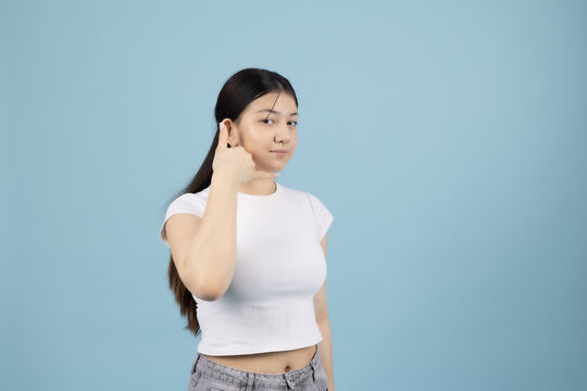 Young woman looking up with hand on forehead