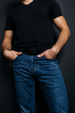 a young guy with skinny legs in jeans, below the waist: a fly and pockets for money or condoms. a pose from psychology: waiting in a store queue or on a date with a girl. street style in clothing: cla