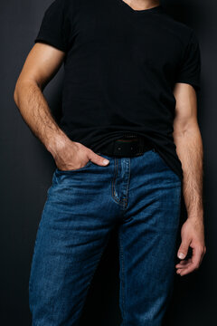 a young guy with skinny legs in jeans, below the waist: a fly and pockets for money or condoms. a pose from psychology: waiting in a store queue or on a date with a girl. street style in clothing: cla