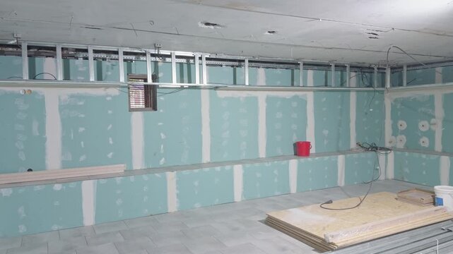 Room renovation with drywall wall covering and metal frame on the ceiling