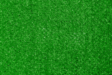 Fototapeta premium artificial plastic synthetic green grass fence close-up texture pattern background backdrop Artificial grass texture woven through a chain link fence creating a vibrant green background for design