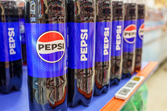 Alanya, Turkey. Bottles of Pepsi soft drink displayed on a shelf in a retail store, vibrant blue labels and clear plastic packaging visible