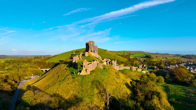 Aerial sunset view of Corfe Castle, a village and civil parish in the English county of Dorset, UK