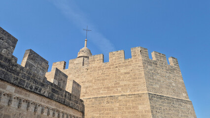 Historic stone fortress wall under blue sky © Studio-M