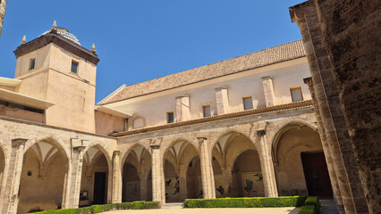 Obraz premium Historic cloister courtyard with arches and tower