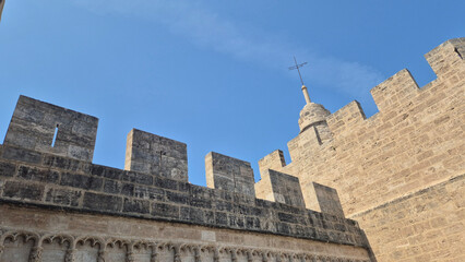 Historic stone fortress wall against blue sky © Studio-M